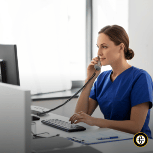 Dental office staff using VoIP to contact patient while accessing practice management software.